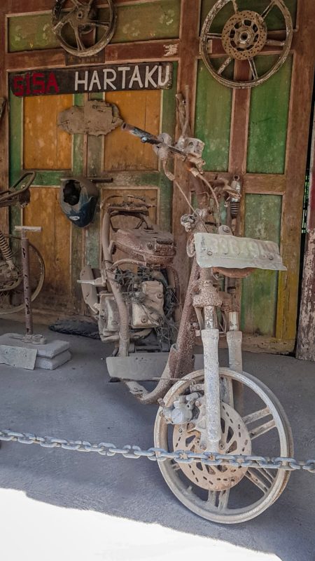 Damaged motorcycle after a volcano eruption at the Mount Merapi open air museum