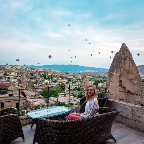 Hot air balloon sunrise watched from Village Cave House hotel balcony in Cappadocia