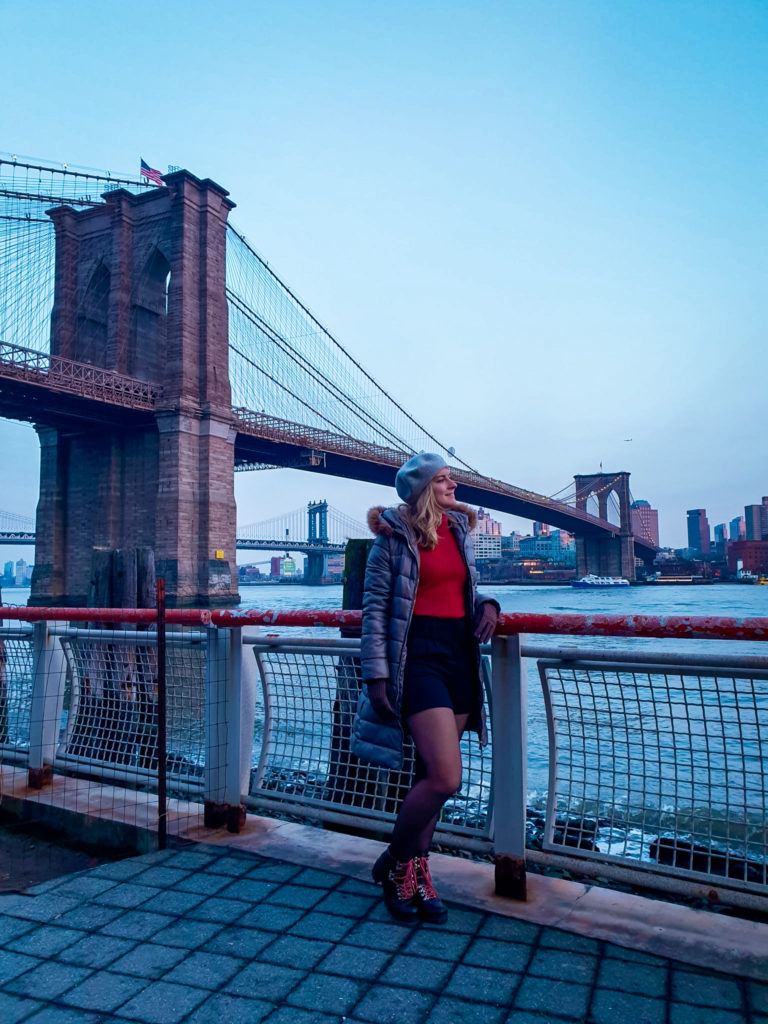 Brooklyn Bridge captured from Manhattan waterside at sunset