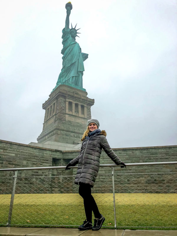 Posing in front of the Statue of Liberty