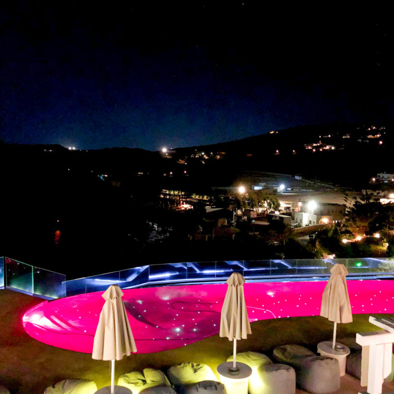 Communal infinity pool at Panormos village hotel in Mykonos at night