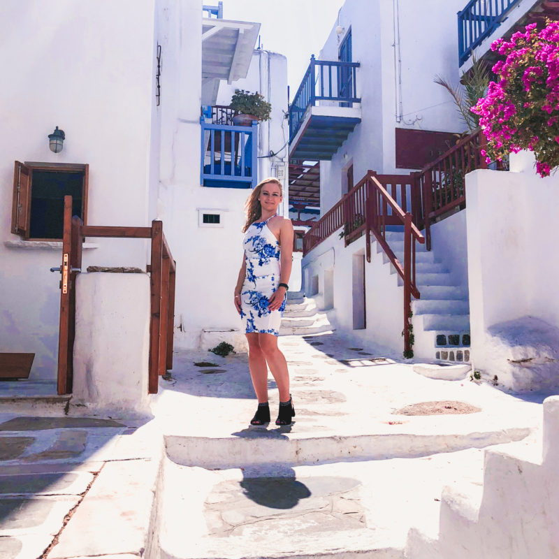 Beautiful blue and white street with flowers in Mykonos Town