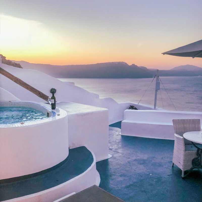 Breakfast table at sunrise with sea views at the Honeymoon Suite (Prime Suites) in Oia, Santorini, Greece