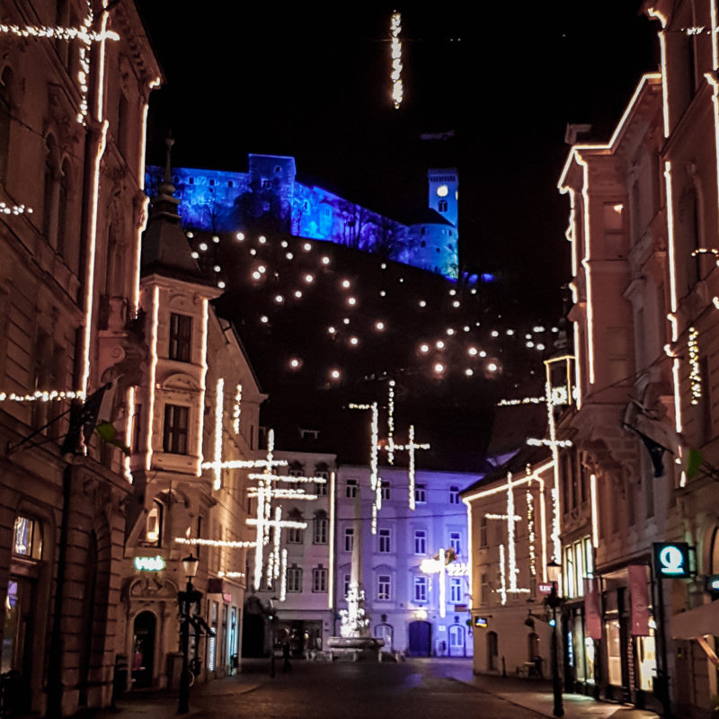 Christmas lights in the streets of Ljubljana with Ljubljana Castle in background