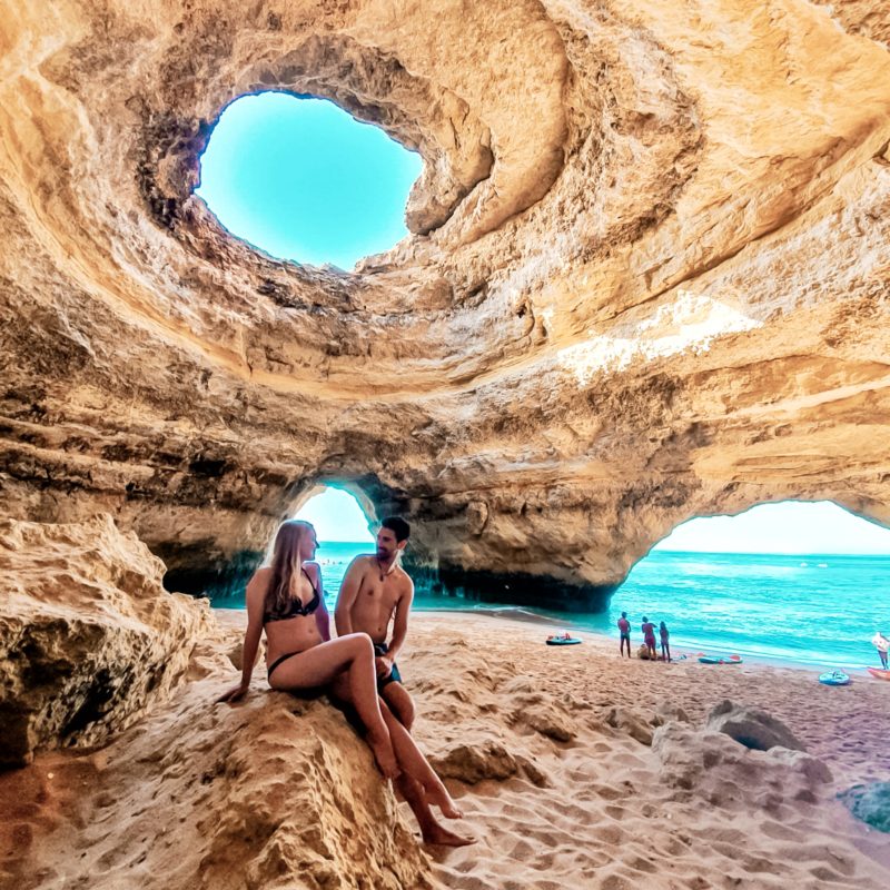 Travel couple posing inside the Benagil Caves, Algarve, Portugal
