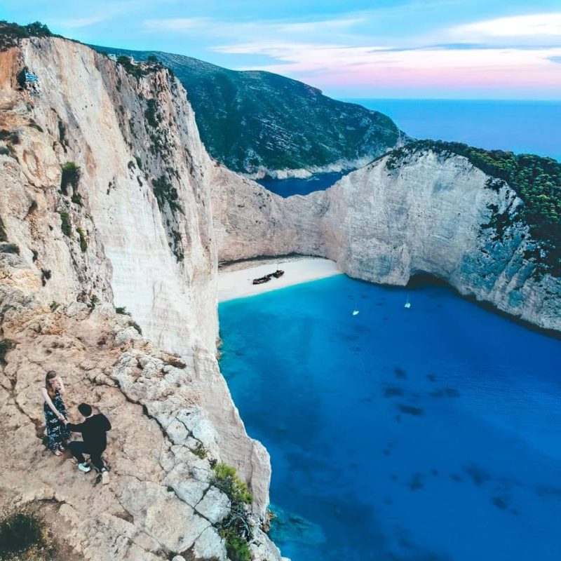 Couple getting engaged at the Shipwreck Beach Viewpoint in Zakynthos, Greece
