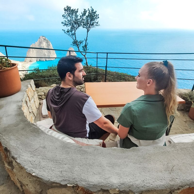 Couple enjoying views from Keri Lighthouse Restaurant in Zakynthos, Greece