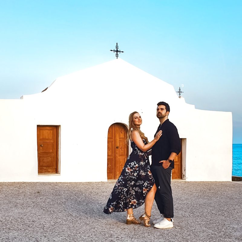Couple posing in front of Chapel Agios Nikolaos in Zakynthos, Greece