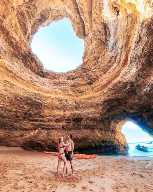 Couple posing at Benagil Caves in Algarve, Portugal
