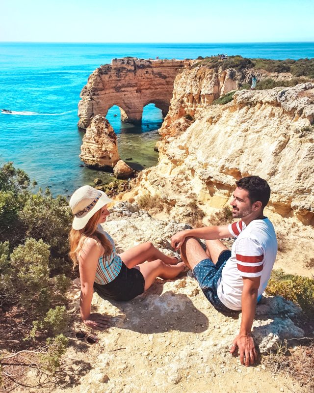 Couple posing at Praia da Marinha in Algarve, Portugal