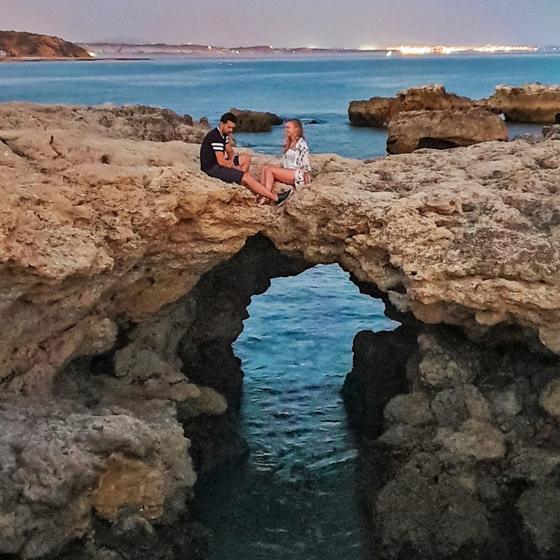 Couple posing at Praia dos Aveiros in Algarve, Portugal