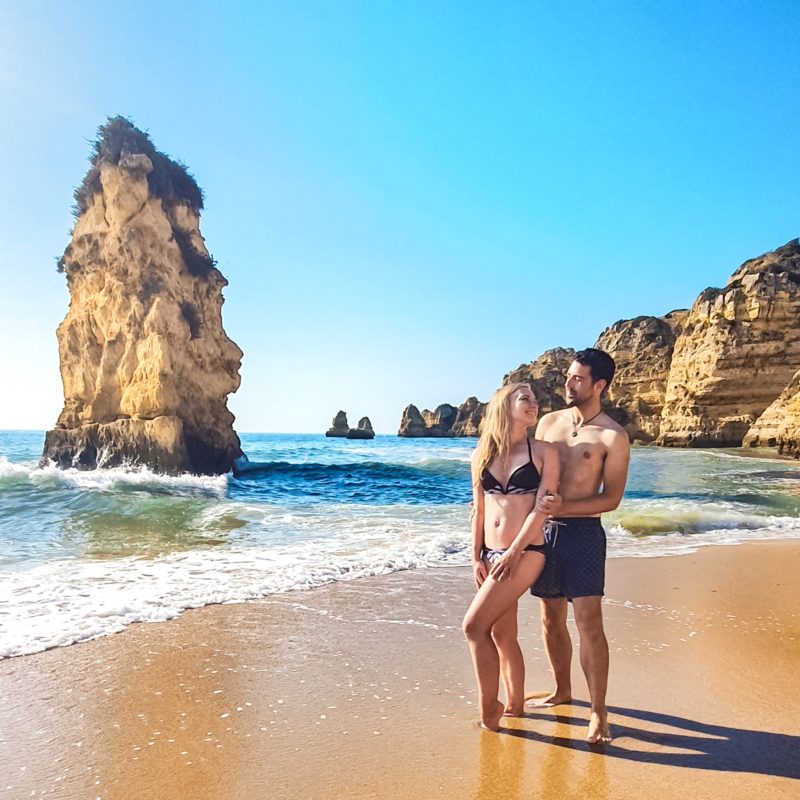 Couple posing at Praia Dona Ana in Algarve, Portugal