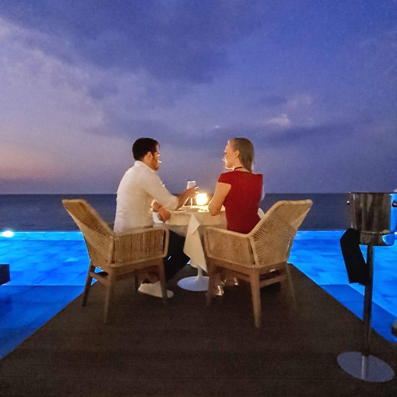 Couple having romantic dinner at infinity pool restaurant in Lesante Blu (Zakynthos, Greece)