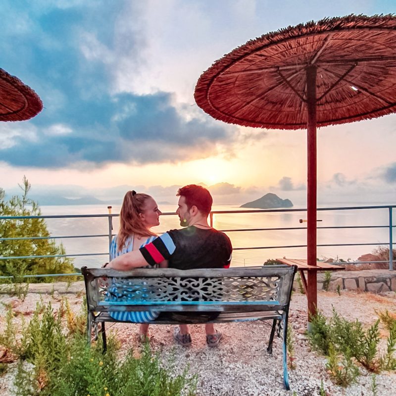 Couple enjoying sunrise with Turtle Island views from Athenea Villas (Zakynthos, Greece)