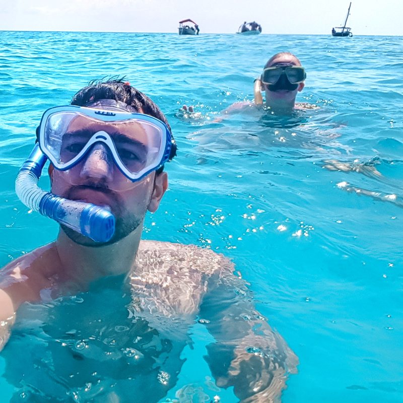 Travel couple snorkeling at Mnemba Atoll in Zanzibar, Tanzania