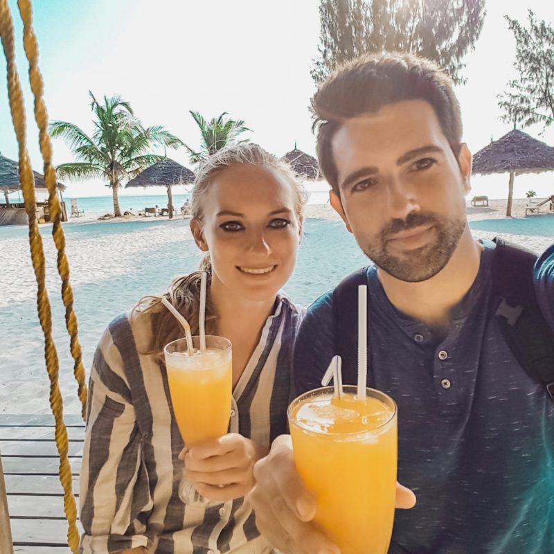 Travel Couple enjoying cocktails at Nungwi Beach in Zanzibar, Tanzania