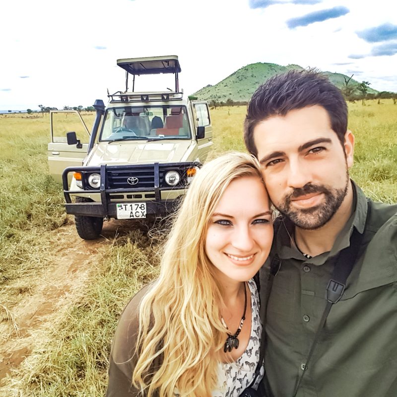 Travel Couple with jeep in Serengeti, Tanzania, Africa