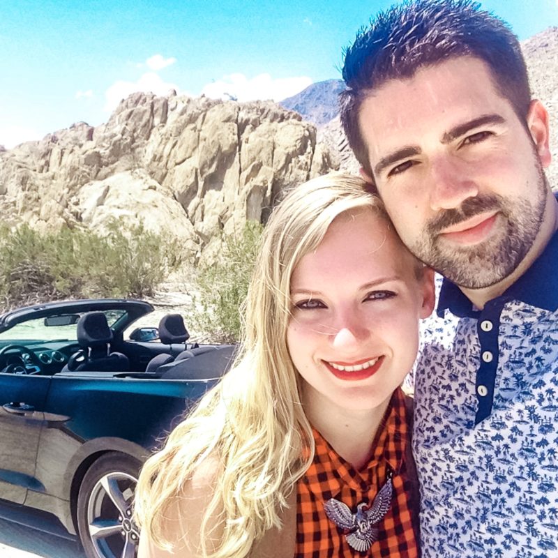 Couple on road trip with Ford Mustang in West Coast USA