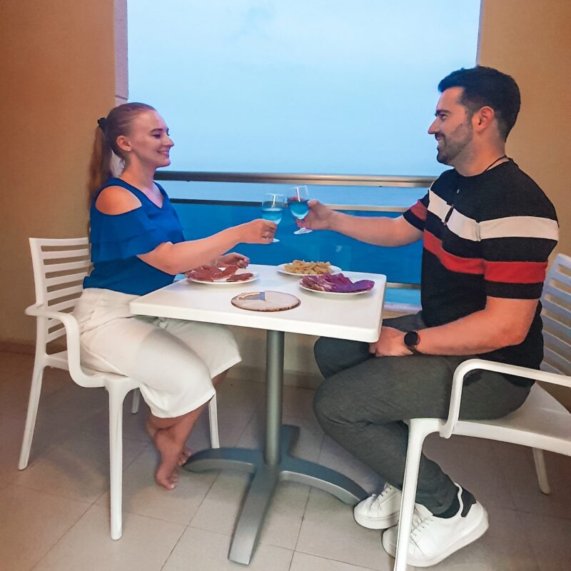 Couple having dinner on balcony at Bahia hotel in Calpe, Costa Blanca, Spain