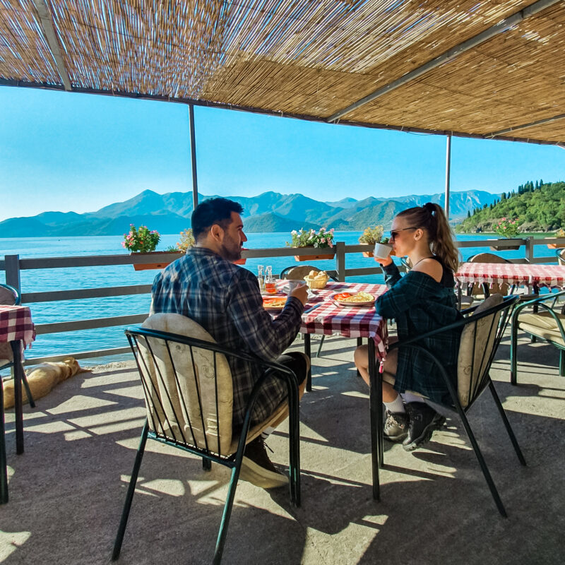 Couple having breakfast with Lake Skadar views in Montenegro