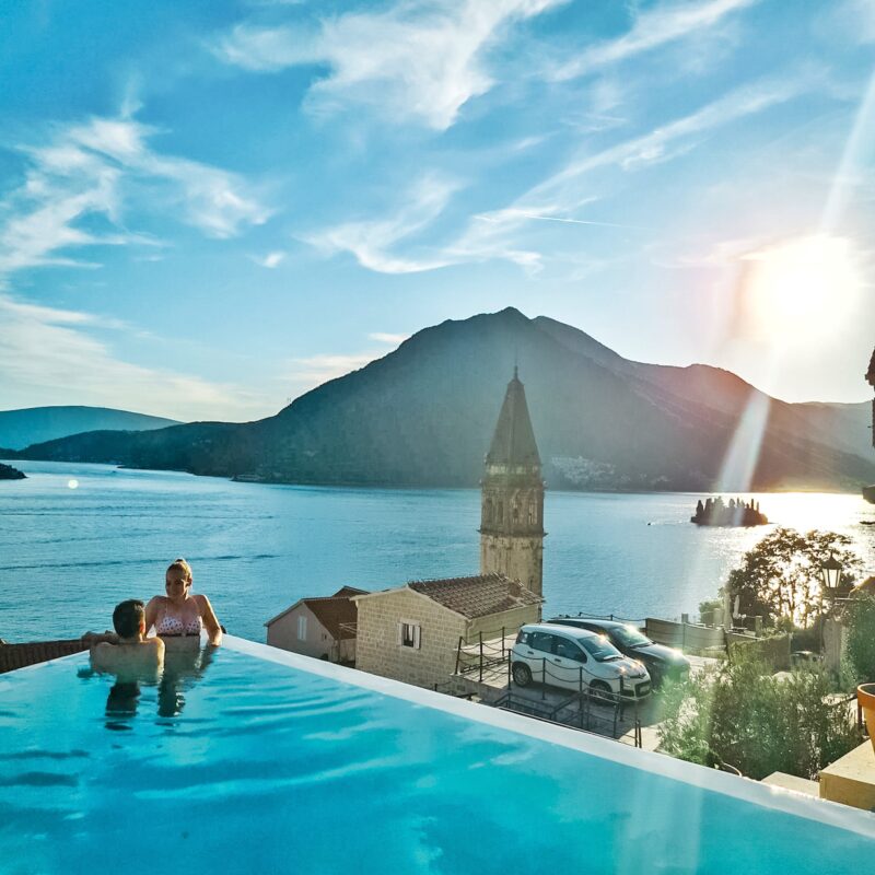 Couple watching sunset from infinity pool at Monte Bay Retreat in Montenegro