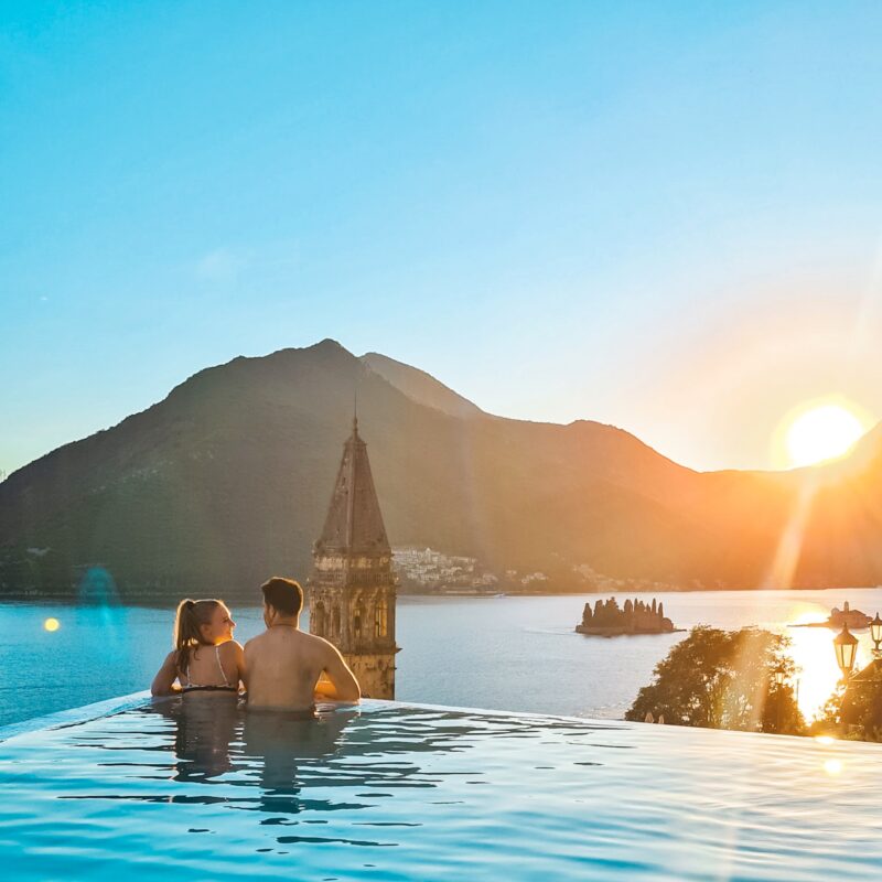 Couple watching sunset from infinity pool at Monte Bay Retreat in Montenegro