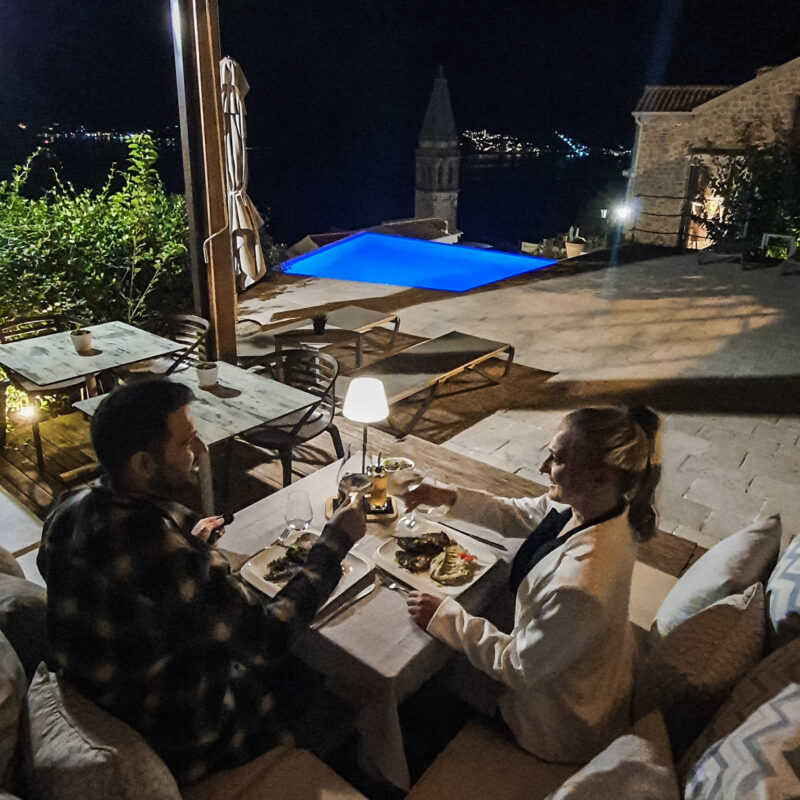 Couple having private dinner at infinity pool in Monte Bay Retreat (Montenegro)