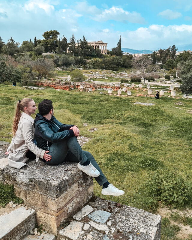 Travel Couple posing at a viewpoint at the Ancient Agora of Athens, Greece