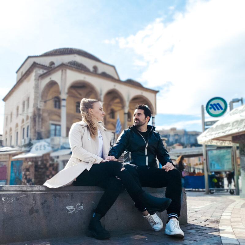 Travel couple posing at Monastiraki Square in Athens, Greece