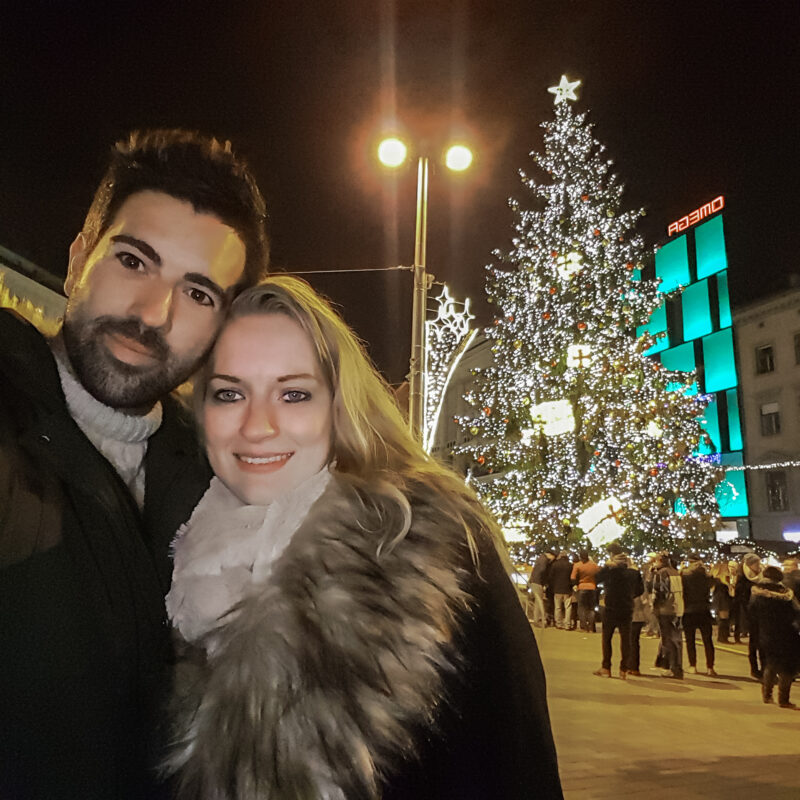 Couple posing with Christmas tree in Brno