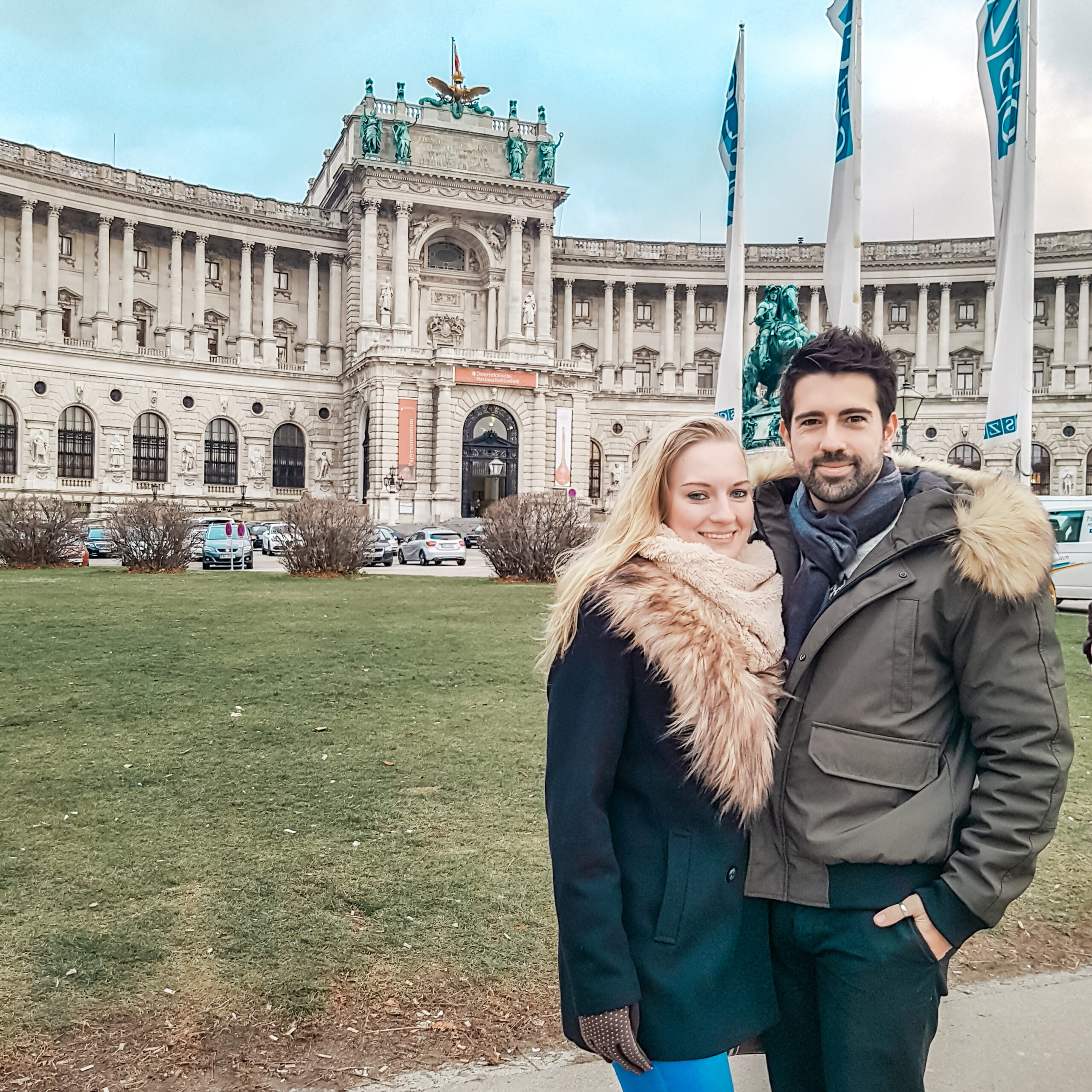 Couple posing in front of Hofburg Palace in Vienna, Austria