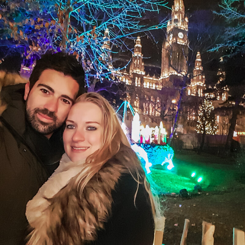 Couple posing with Christmas lights in Vienna, Austria