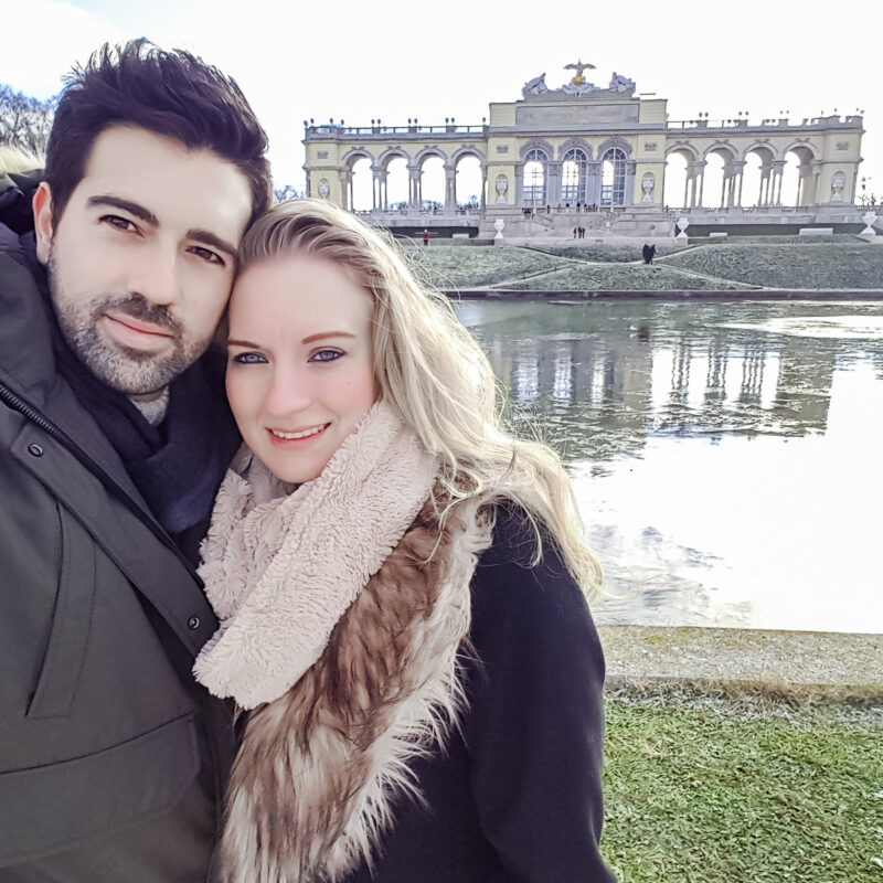 Couple posing in the gardens of Schonbrunn Palace in Vienna, Austria