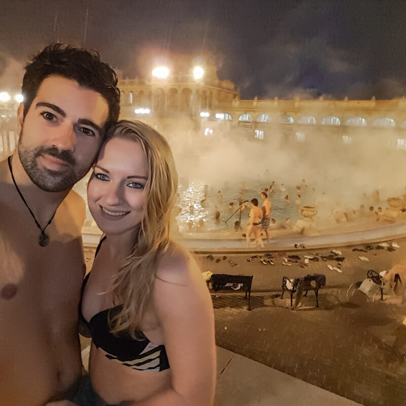 Couple enjoying the Széchenyi Thermal Bath spa in Budapest at night