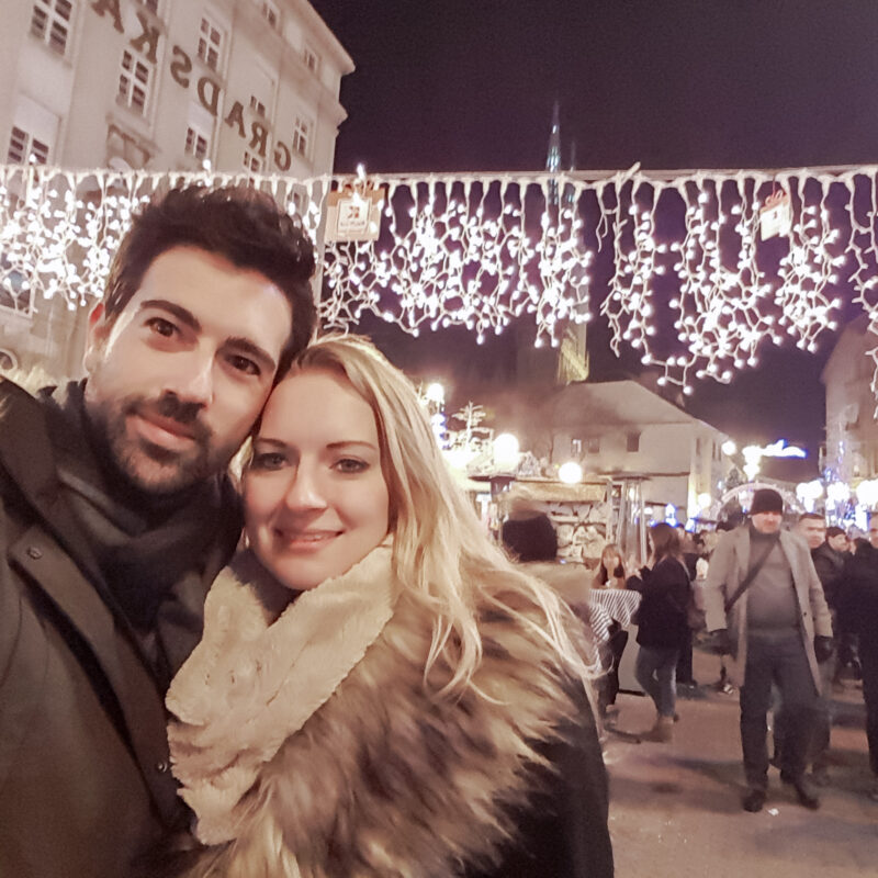 Couple posing at Christmas market in Zagreb, Croatia