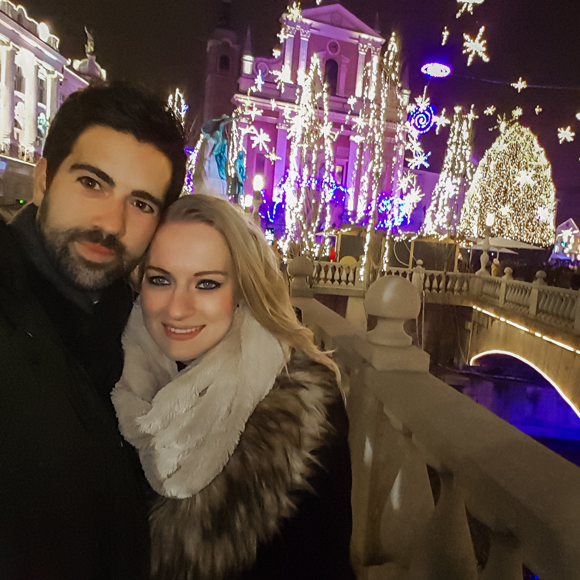Couple posing with Christmas lights in Ljubljana, Slovenia