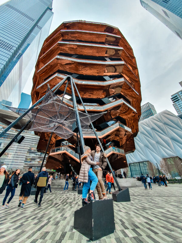 Travel Couple admiring the Vessel in the Hudson Yards neighbourhood of New York City