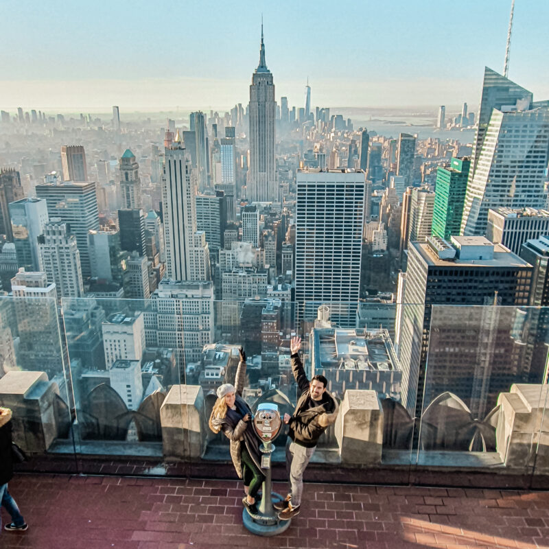 Travel Couple admiring the New York City skyline at Top of the Rock
