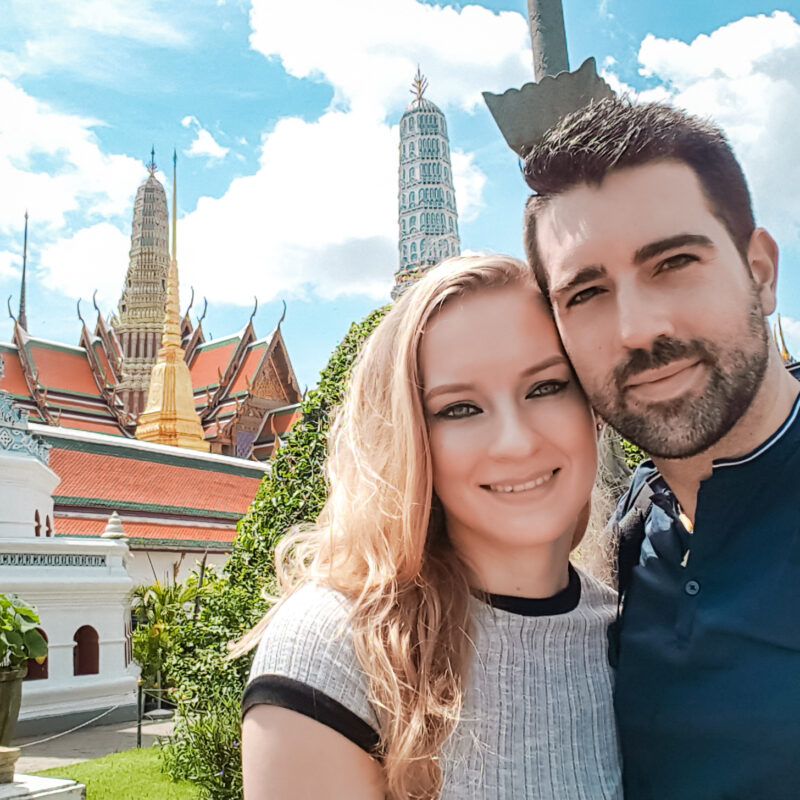 Travel Couple taking a selfie in front of The Grand Palace in Bangkok, Thailand