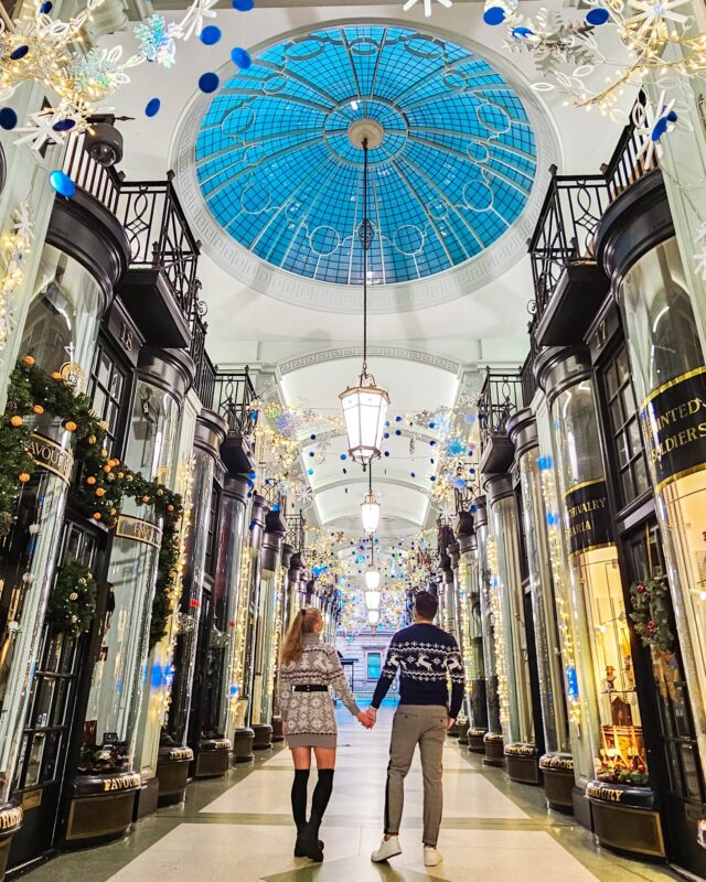 Travel Couple posing with Christmas Decorations at the Piccadilly Arcade in London