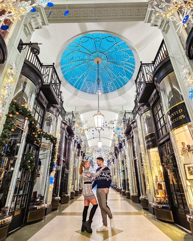 Travel Couple posing with Christmas Decorations at the Piccadilly Arcade in London