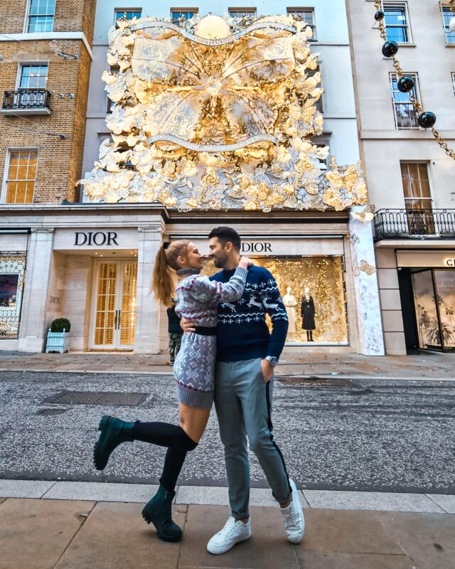 Travel Couple posing with Christmas Decorations at the Dior store in New Bond Street London