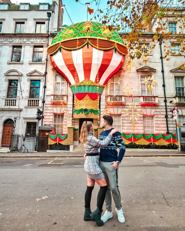 Travel Couple posing with Christmas Decorations at Annabel's in Mayfair London