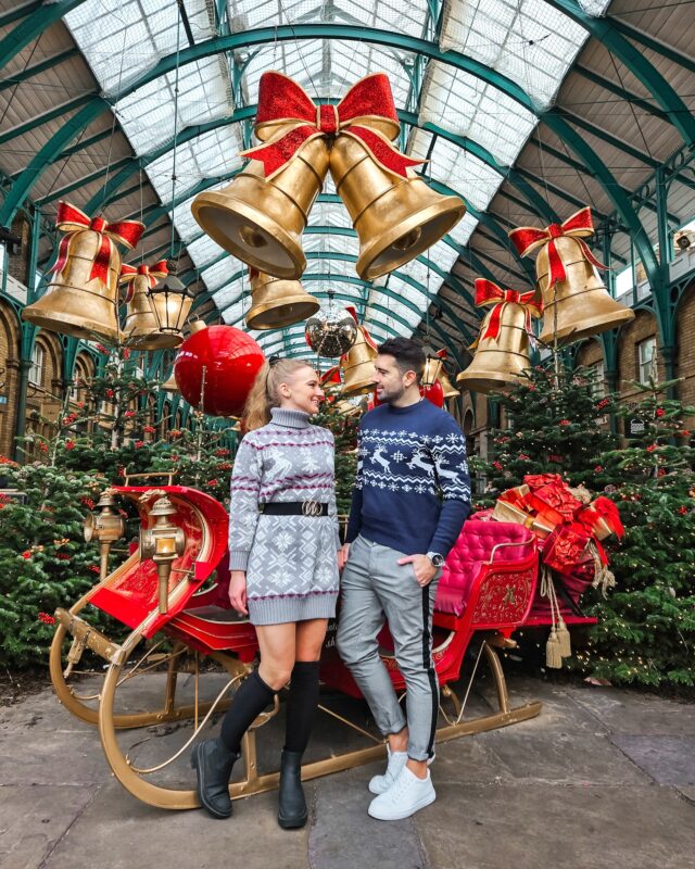 Travel Couple posing with the Christmas Decorations in Covent Garden, London