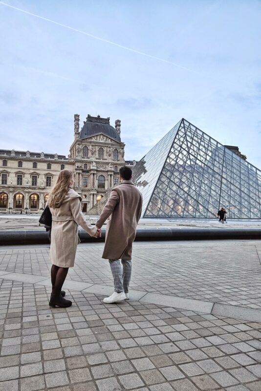 Romantic Photo Spots in Paris for Couples - Travel Couples Posing in front of the Louvre