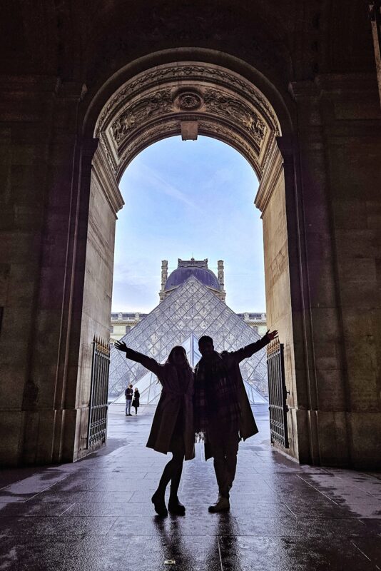 Romantic Photo Spots in Paris for Couples - Travel Couples Posing in front of the Louvre