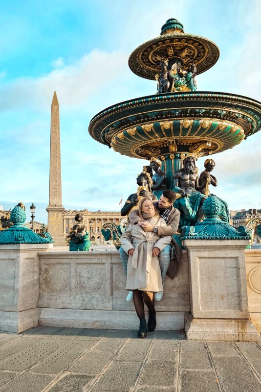 Romantic Photo Spots in Paris for Couples - Travel Couple posing in front of Fountain of Rivers, Place de la Concorde