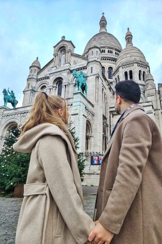 Romantic Photo Spots in Paris for Couples - Travel Couple Posing in front of the Sacre Coeur (portrait mode)