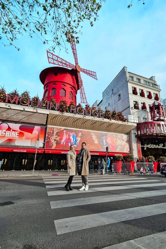 Romantic Photo Spots in Paris for Couples - Travel Couple Posing in front of the Moulin Rouge