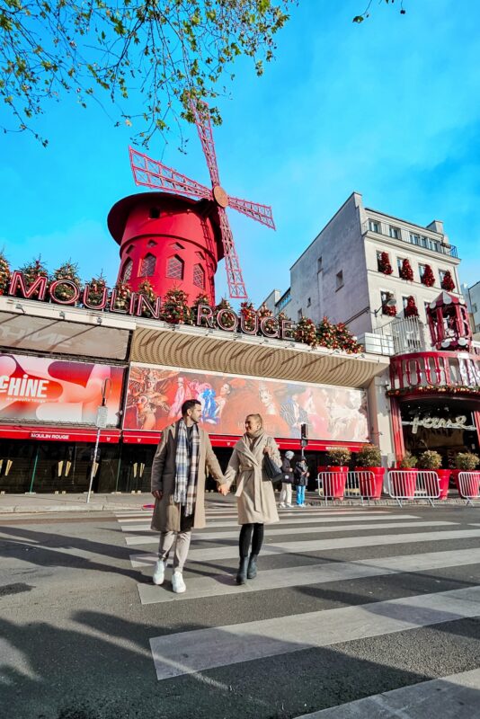 Romantic Photo Spots in Paris for Couples - Travel Couple Posing in front of the Moulin Rouge